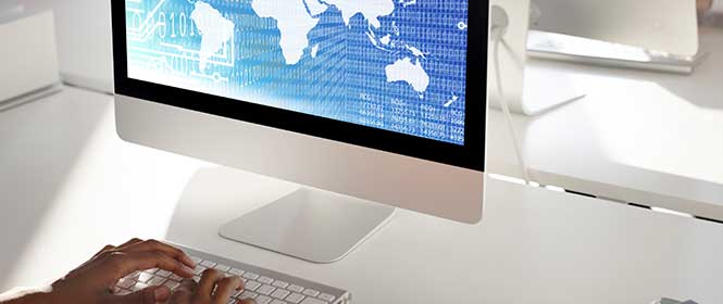 o-que-e-seguro-internacional-de-cargas O que é seguro internacional de cargas? Na imagem, pessoa utilizando o computador evidencia a importância do rastreio para manter a segurança no transporte internacional de cargas